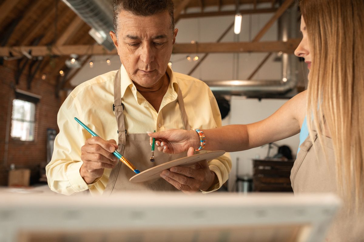 Two colleagues carefully reviewing a piece of work together